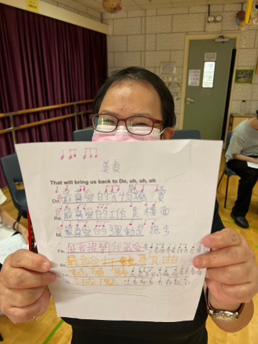 Mei ching holding a paper music sheet