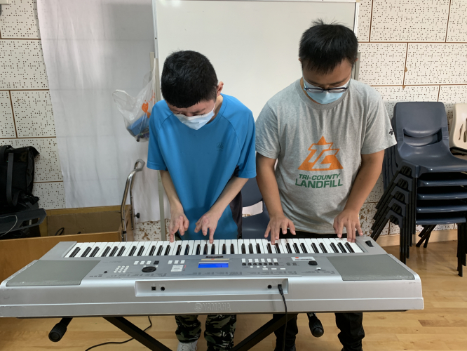 Yu-fai and Mak sir playing eletronic keyboard together